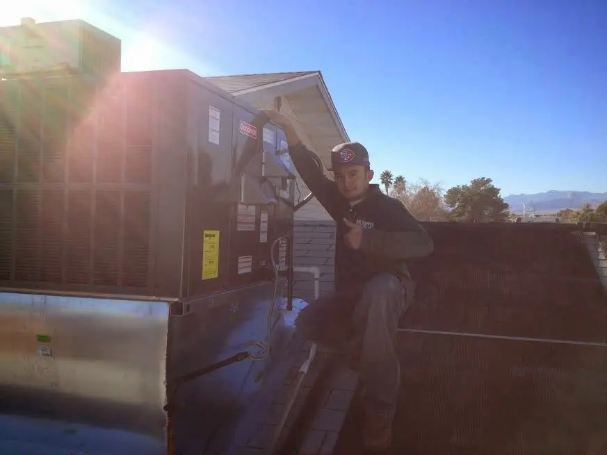 HVAC technician performing AC Tune-Up on a rooftop unit in Walnut Creek